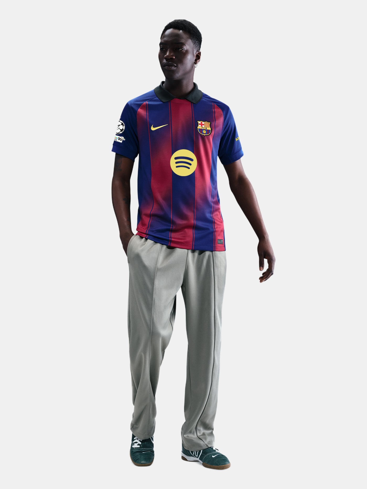 "Male model wearing the official FC Barcelona 2025/26 home jersey yellow Nike and Spotify logos, and UEFA Champions League patch on the sleeve."