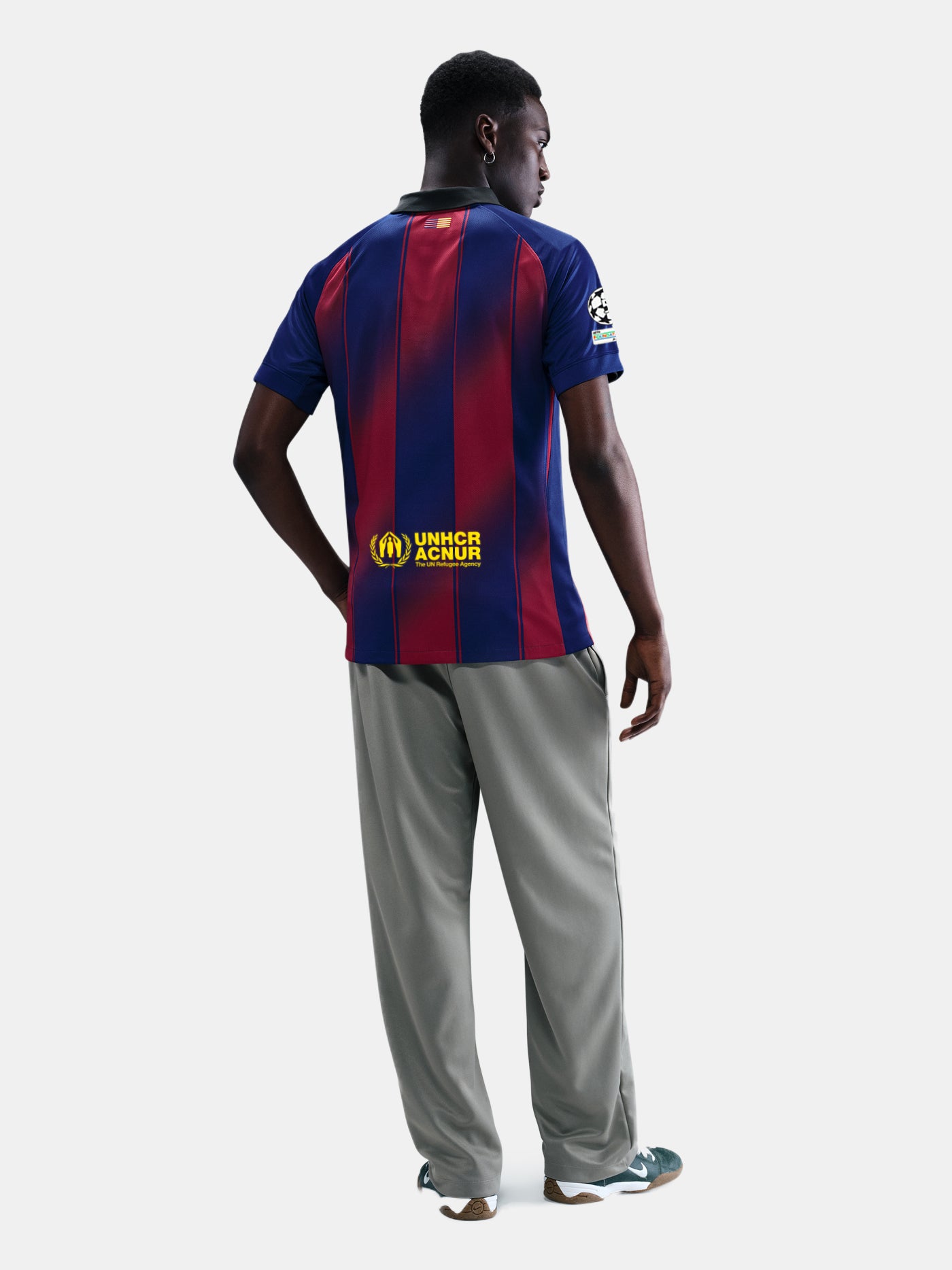 "Male model wearing the official FC Barcelona 2025/26 home jersey yellow Nike and Spotify logos, and UEFA Champions League patch on the sleeve."