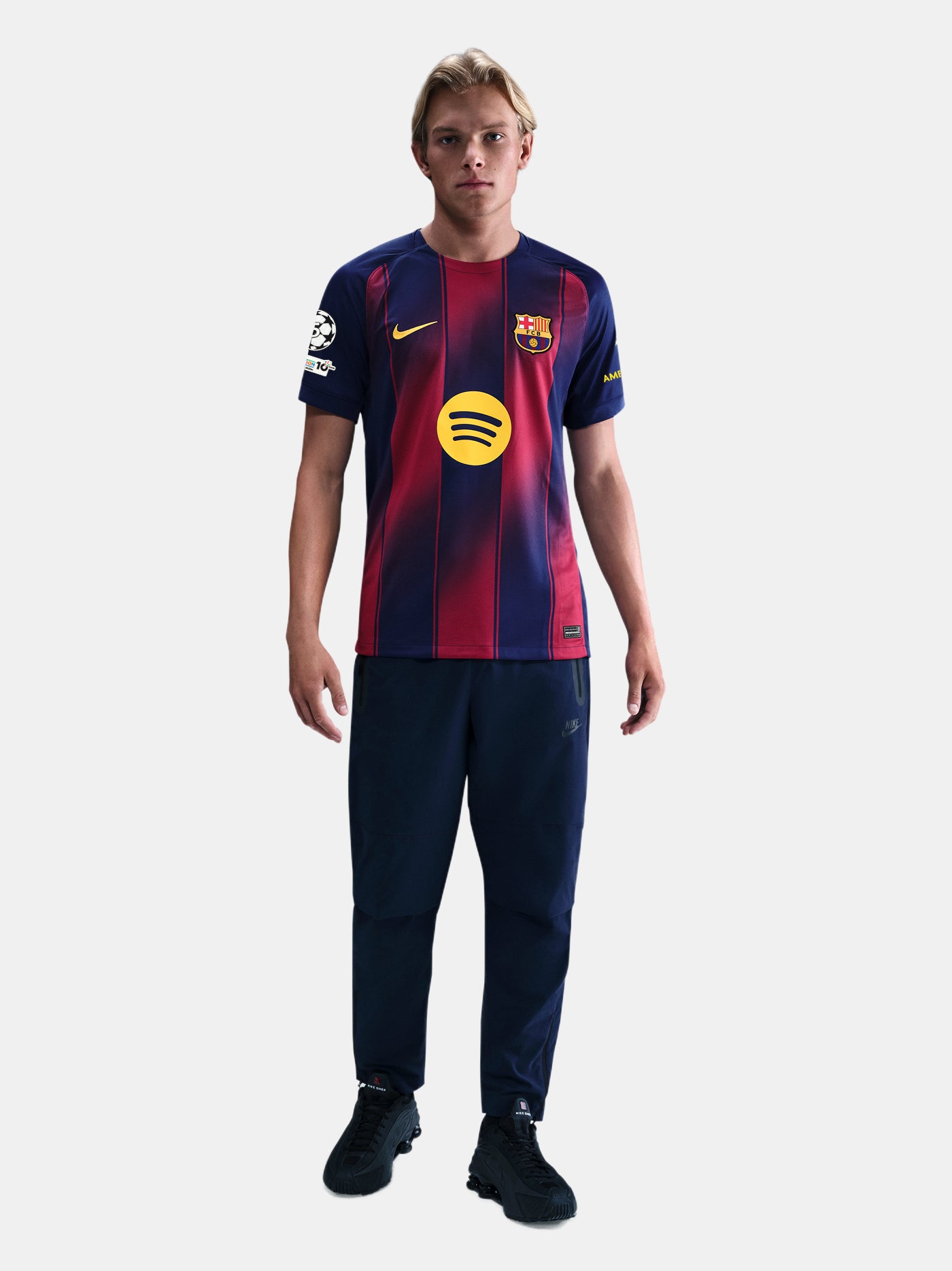"Male model wearing the official FC Barcelona 2025/26 home jersey yellow Nike and Spotify logos, and UEFA Champions League patch on the sleeve."