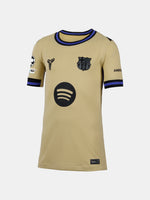 Beige sports jersey with black logo and branding on a white background