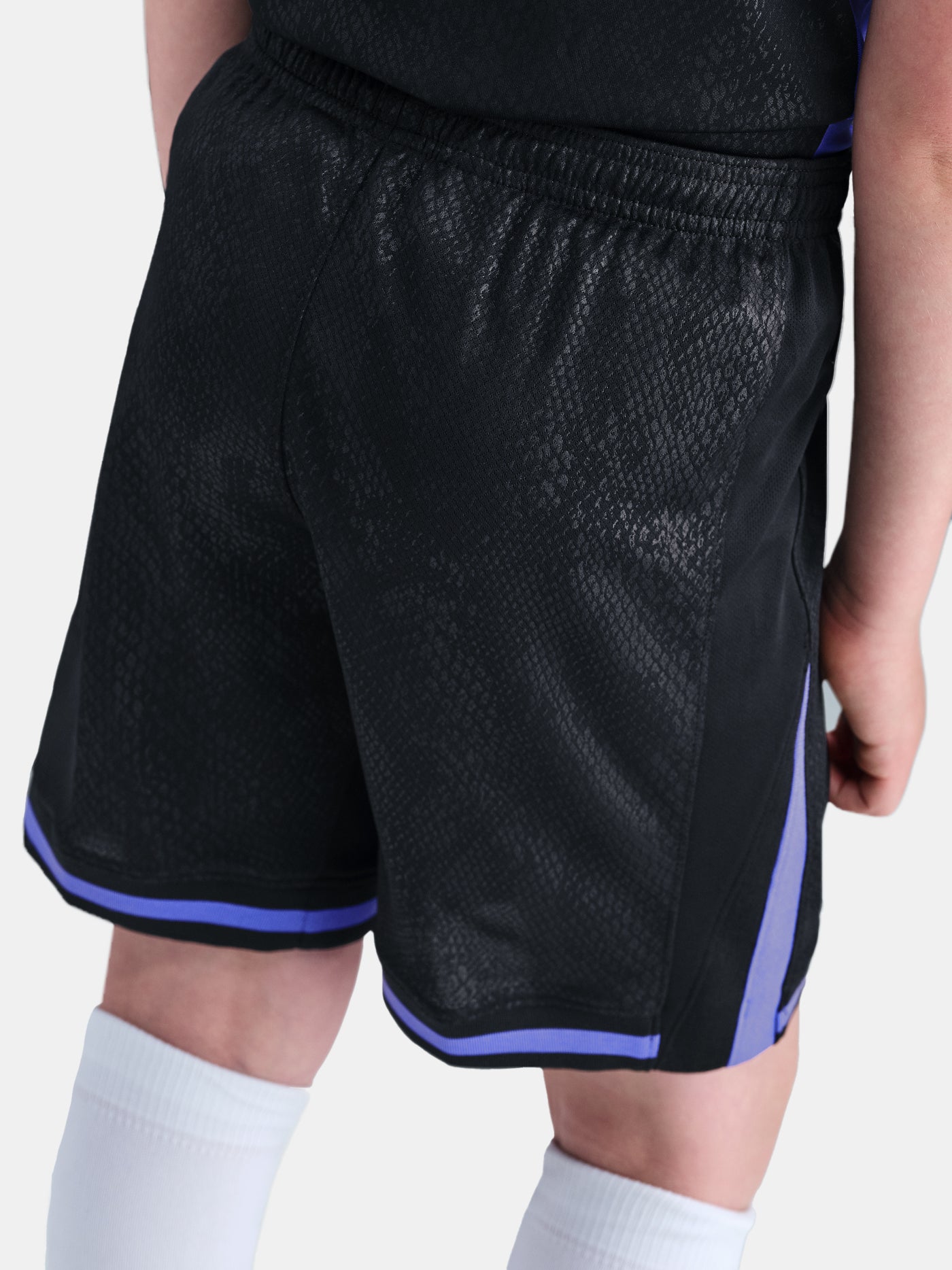 Black shorts with purple accents worn by a person on a white background