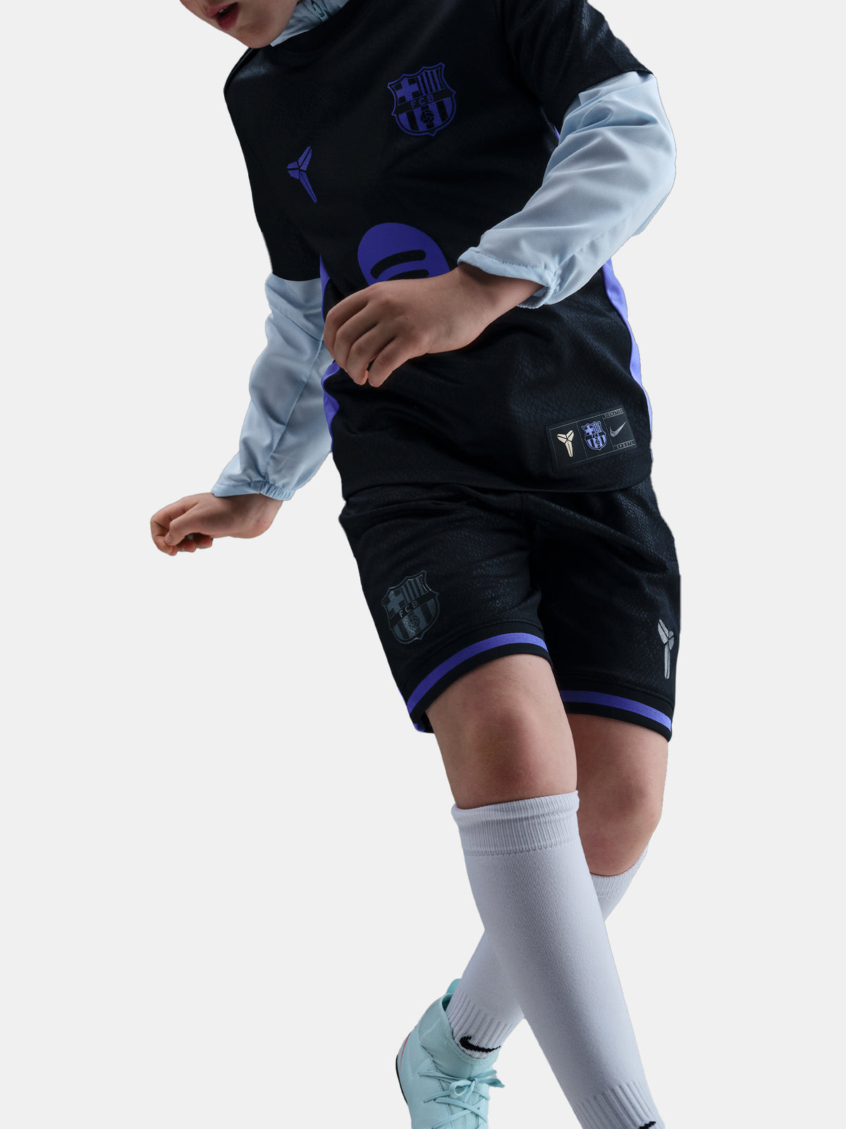 Person wearing a black sports outfit with purple accents on a white background