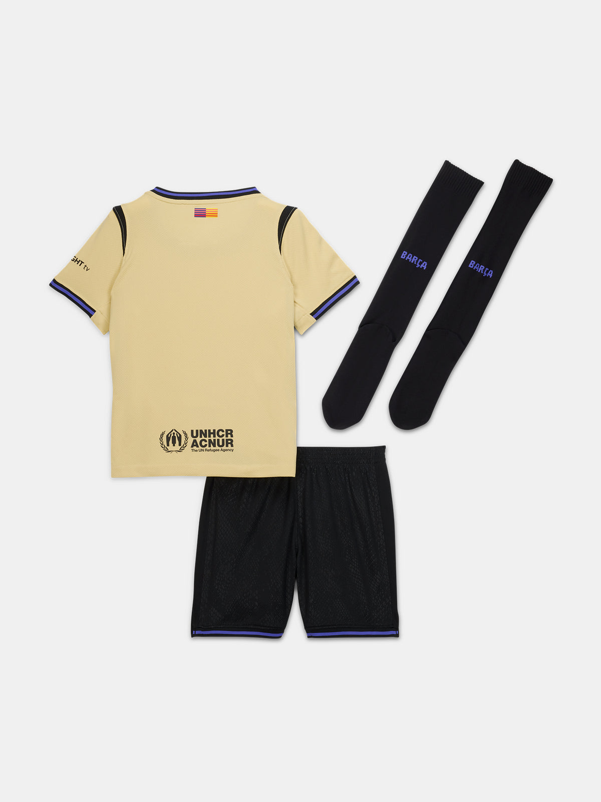 FC Barcelona kids' away kit set including beige jersey with black and purple details, black shorts with purple accents, and matching black socks, featuring club crest, Nike logo, Spotify sponsor, and Kobe Bryant tribute emblem.
