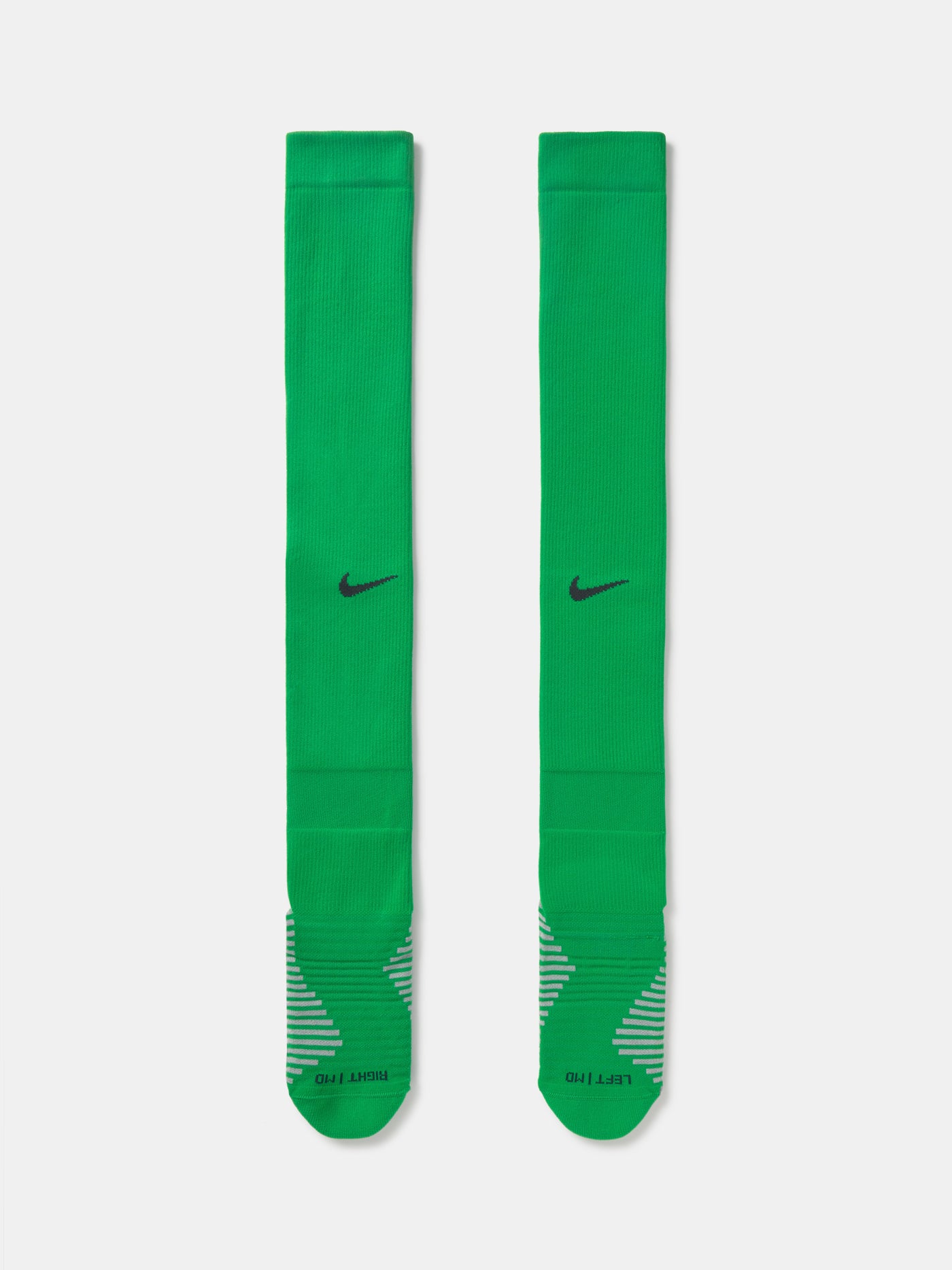 Pair of green Nike over-the-knee football socks with black swoosh and cushioned sole