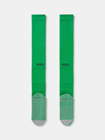Pair of green Nike over-the-knee football socks with black swoosh and cushioned sole