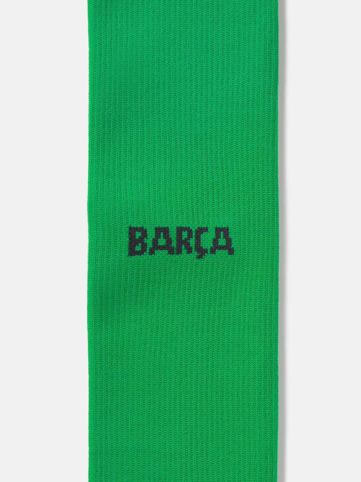 Pair of green Nike over-the-knee football socks with black swoosh and cushioned sole