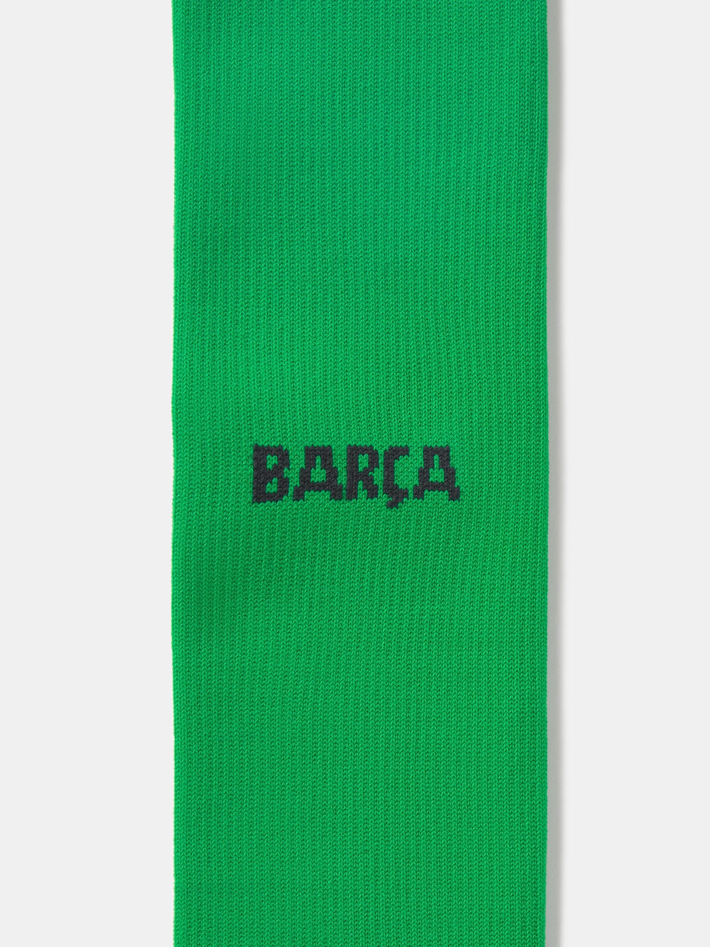 Pair of green Nike over-the-knee football socks with black swoosh and cushioned sole