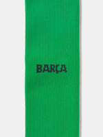 Pair of green Nike over-the-knee football socks with black swoosh and cushioned sole