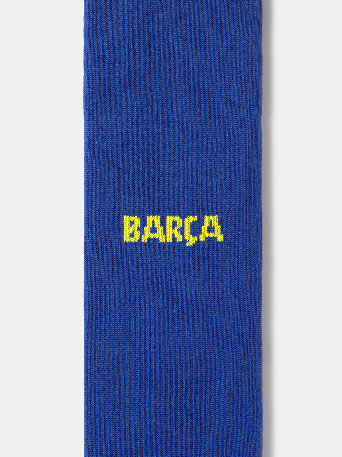 Blue Nike sock with yellow swoosh logo on a white background