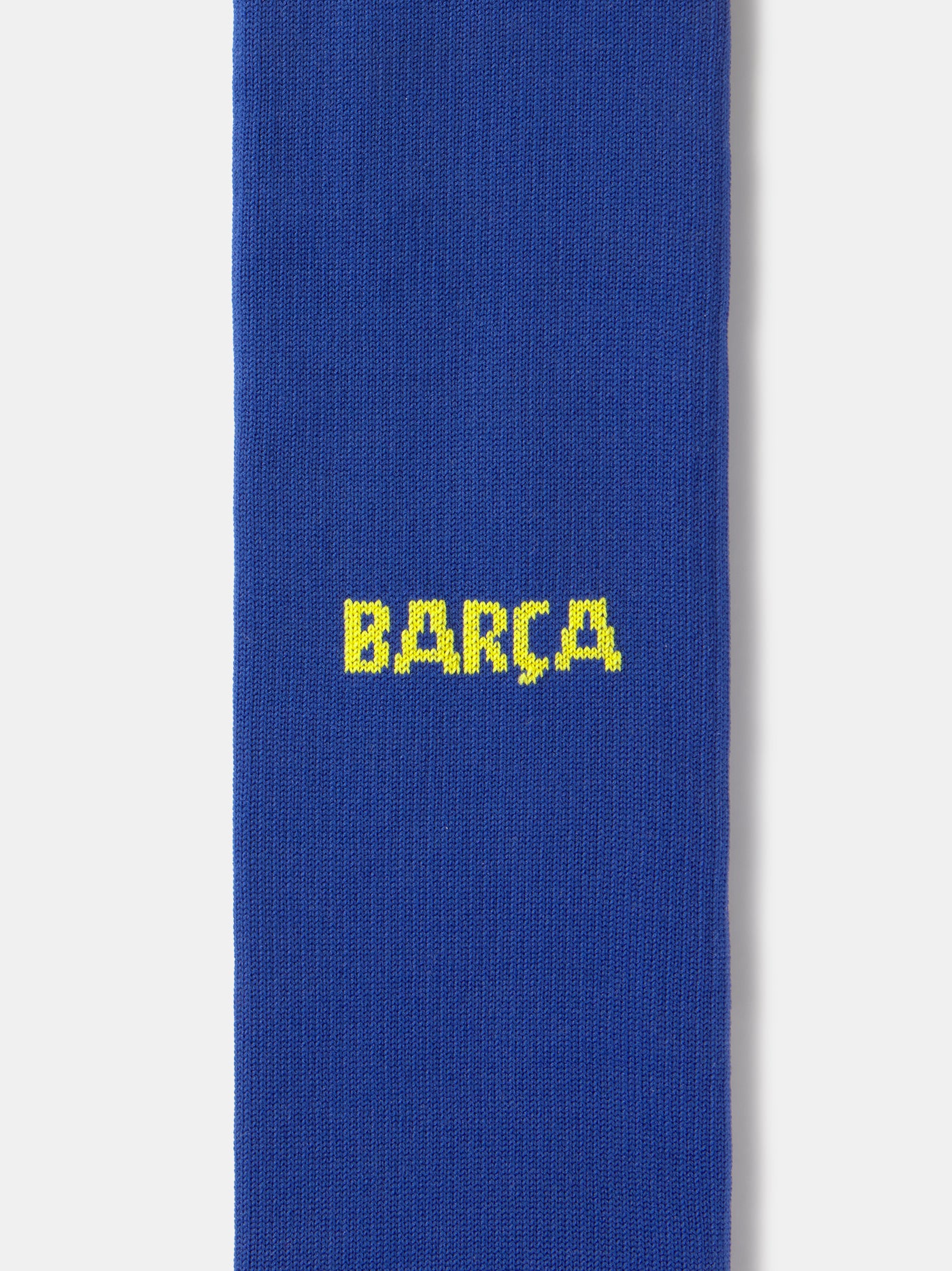 Blue Nike sock with yellow swoosh logo on a white background