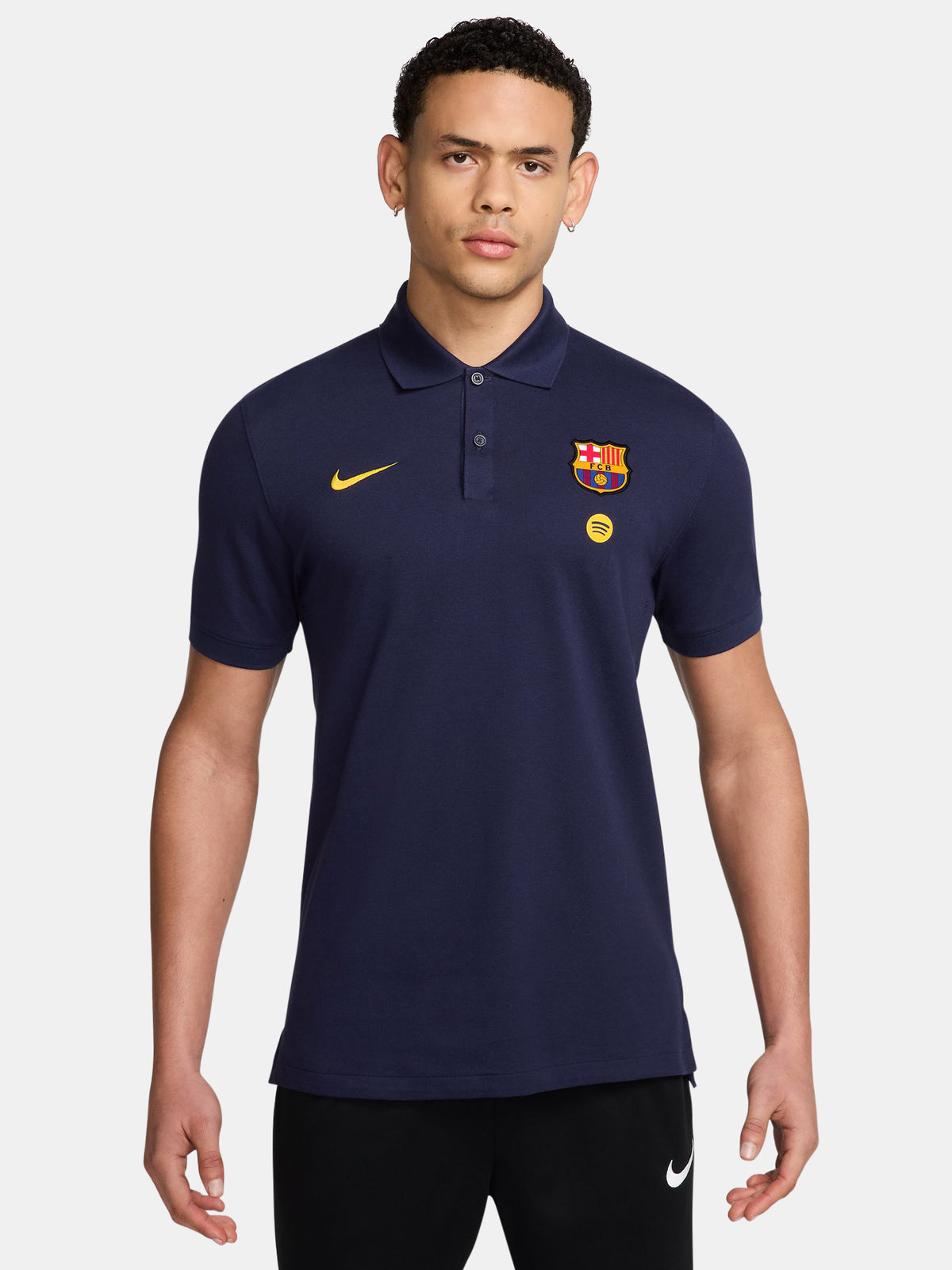 FC Barcelona polo shirt in deep navy. This classic collared polo features the Barça crest and a small Spotify logo on the chest, paired with a yellow Nike swoosh. Designed for a clean, sporty look perfect for both matchday and everyday wear.
