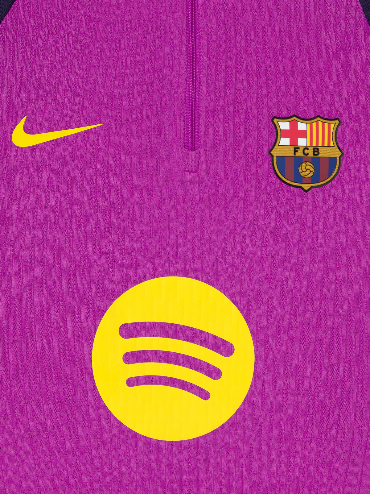 Purple and navy FC Barcelona Nike training top with long sleeves, featuring yellow swoosh, club crest, and Spotify logo on the front.