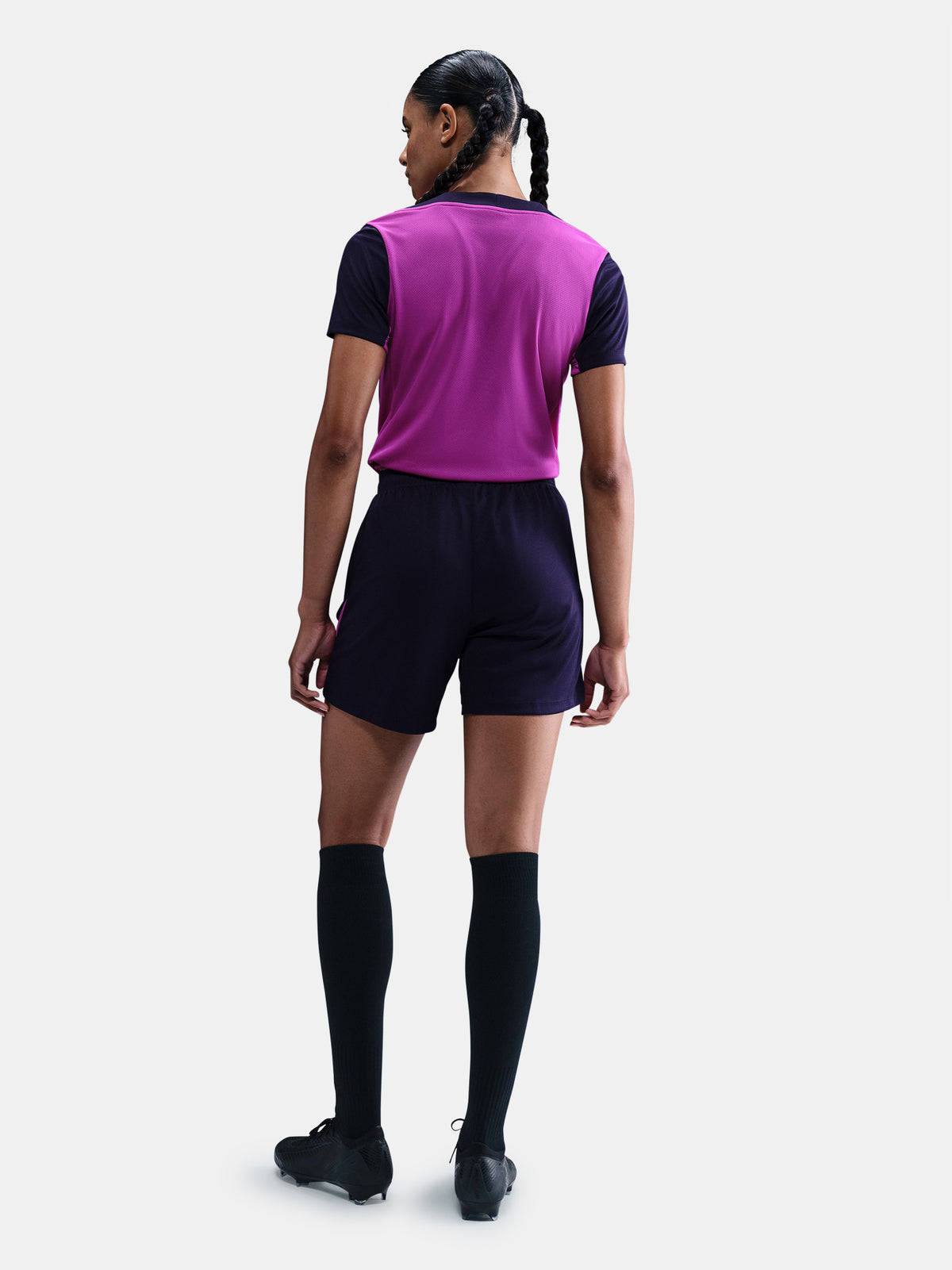 Women's purple FC Barcelona training jersey with navy sleeves, yellow Nike logo, club crest, and Spotify sponsor on the front.