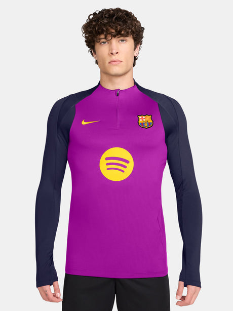 Purple FC Barcelona training top with quarter-zip, navy sleeves, yellow Nike logo, club crest, and Spotify sponsor on the front