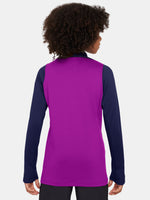 FC Barcelona long-sleeve training top for kids in a vibrant purple body with navy blue sleeves. The top features a yellow Nike swoosh, the Spotify sponsor logo in yellow, and the official Barça crest on the chest. Designed with a half-zip neckline for adjustable ventilation and performance-ready comfort.
