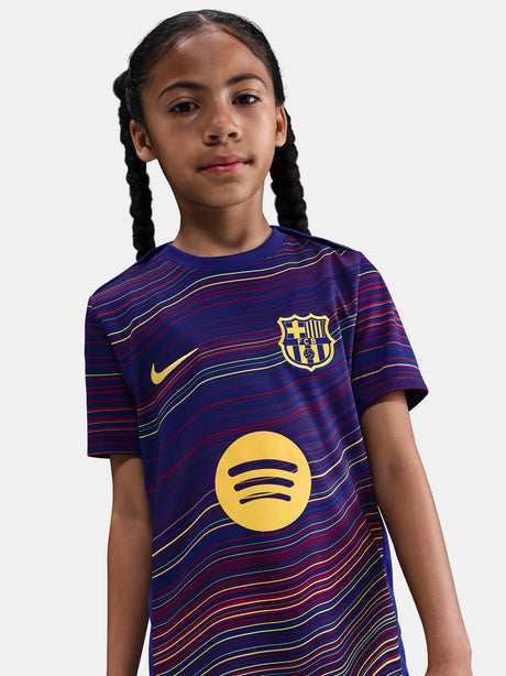 Junior FC Barcelona pre-match jersey with multicolor wave pattern, yellow Nike logo, club crest, and Spotify sponsor on the front
