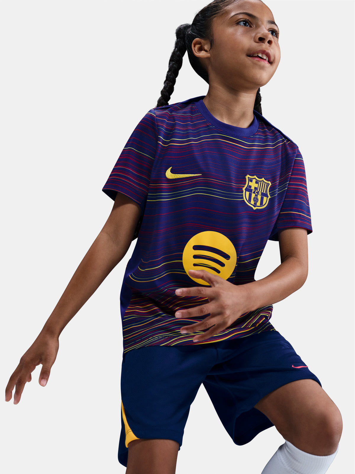 Junior FC Barcelona pre-match jersey with multicolor wave pattern, yellow Nike logo, club crest, and Spotify sponsor on the front