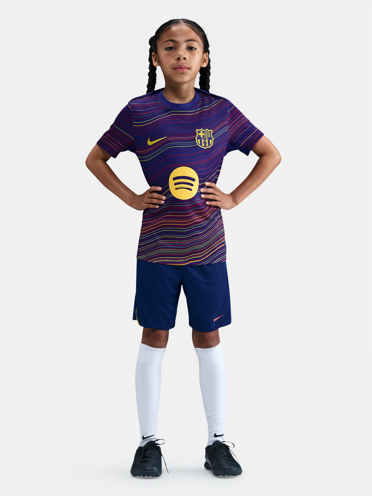 Junior FC Barcelona pre-match jersey with multicolor wave pattern, yellow Nike logo, club crest, and Spotify sponsor on the front