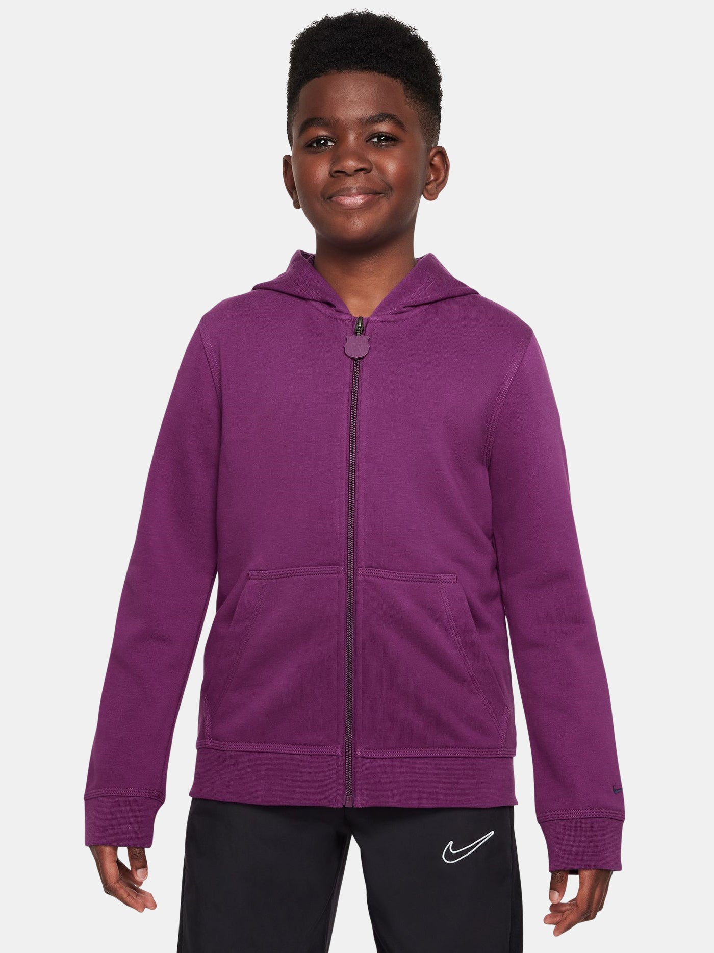 Child wearing a purple hoodie with a white Nike logo on a light gray background