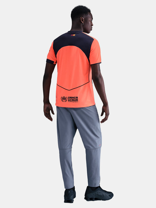 FC Barcelona third kit football jersey in orange with navy blue details, featuring Spotify sponsor logo and Nike branding.
