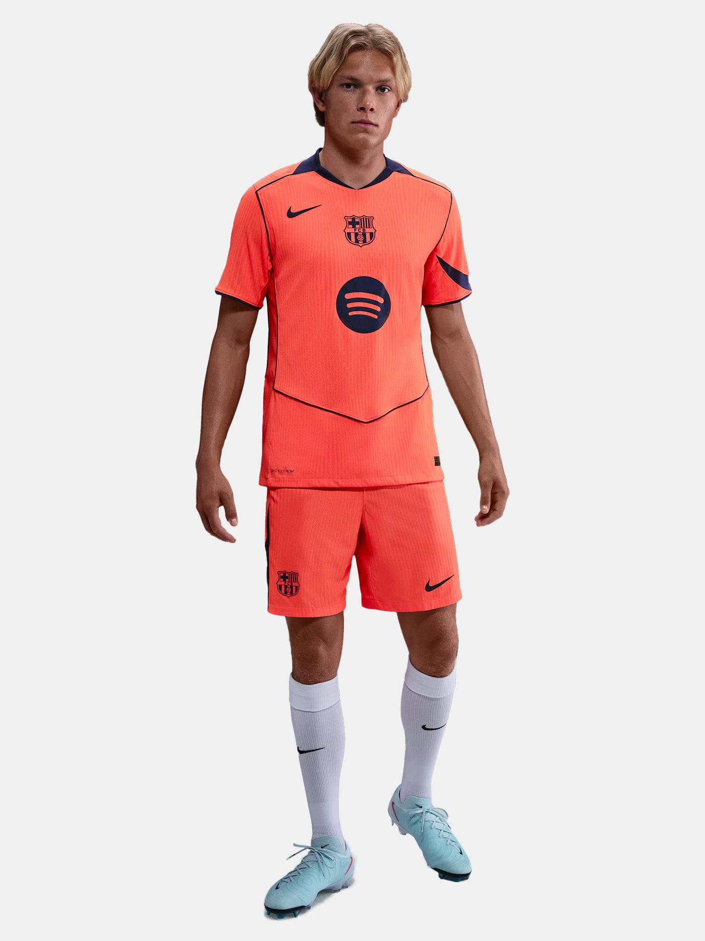 FC Barcelona third kit football shorts in orange with navy blue Nike logo and club crest
