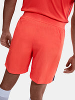 FC Barcelona third kit football shorts in orange with navy blue Nike logo and club crest