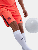 FC Barcelona third kit football shorts in orange with navy blue Nike logo and club crest