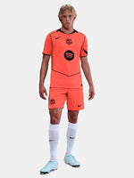 FC Barcelona third kit football shorts in orange with navy blue Nike logo and club crest