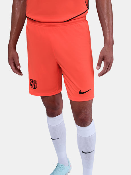 FC Barcelona third kit football shorts in orange with navy blue Nike logo and club crest