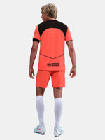 FC Barcelona third kit football shorts in orange with navy blue Nike logo and club crest
