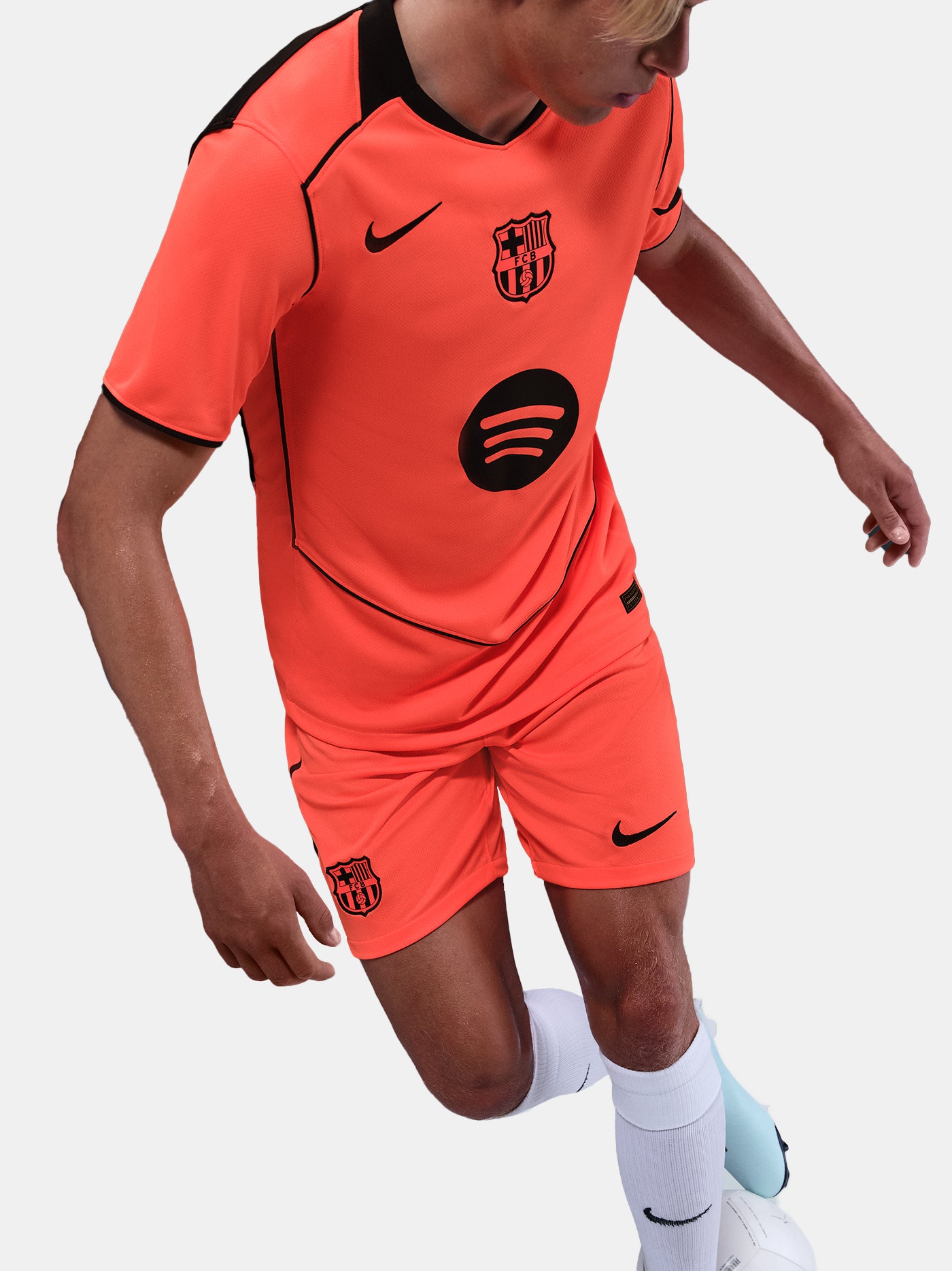 FC Barcelona third kit football shorts in orange with navy blue Nike logo and club crest