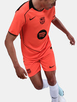 FC Barcelona third kit football shorts in orange with navy blue Nike logo and club crest