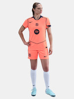 FC Barcelona third kit football shorts in orange with navy blue Nike logo and club crest