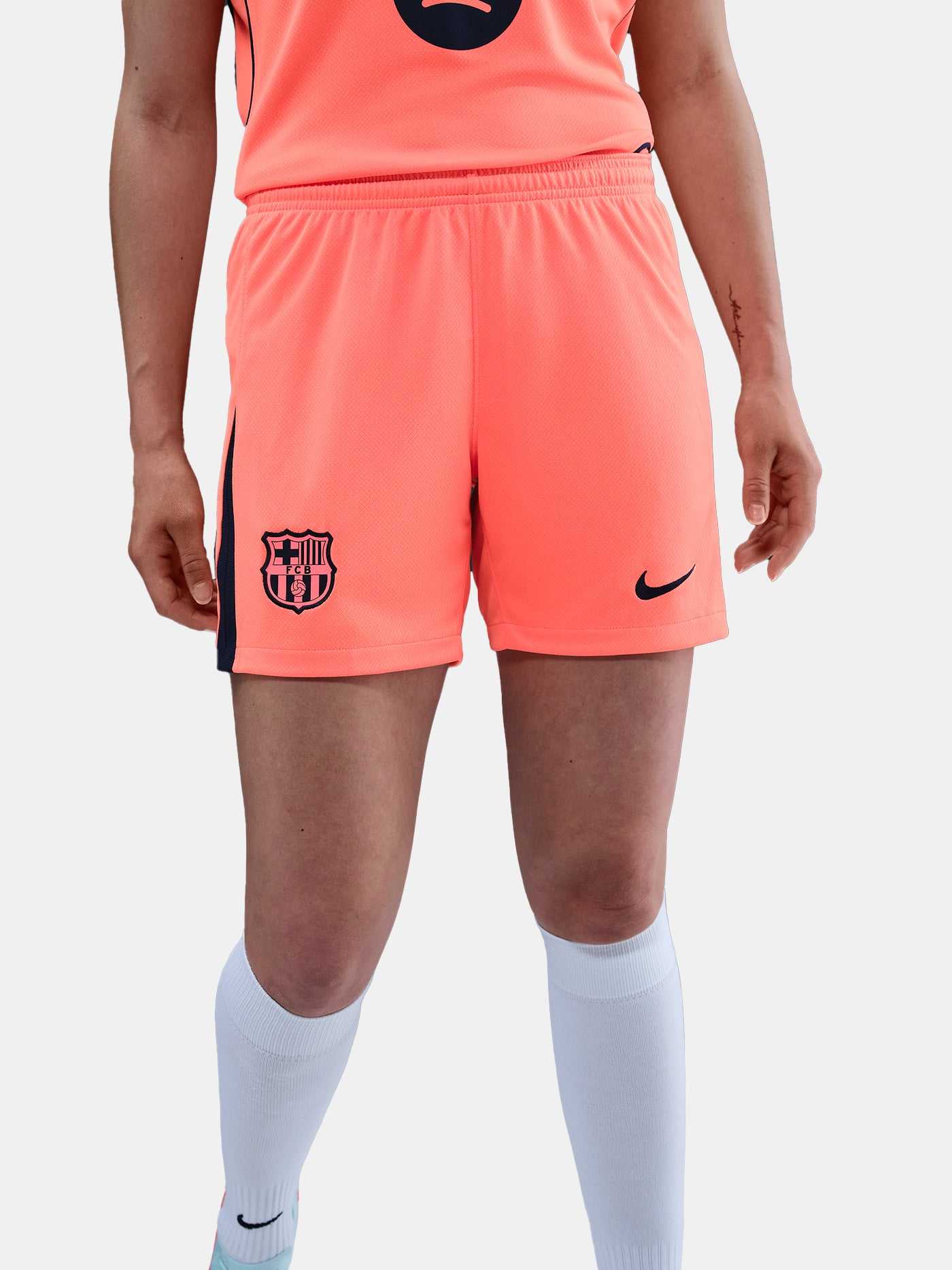 FC Barcelona third kit football shorts in orange with navy blue Nike logo and club crest