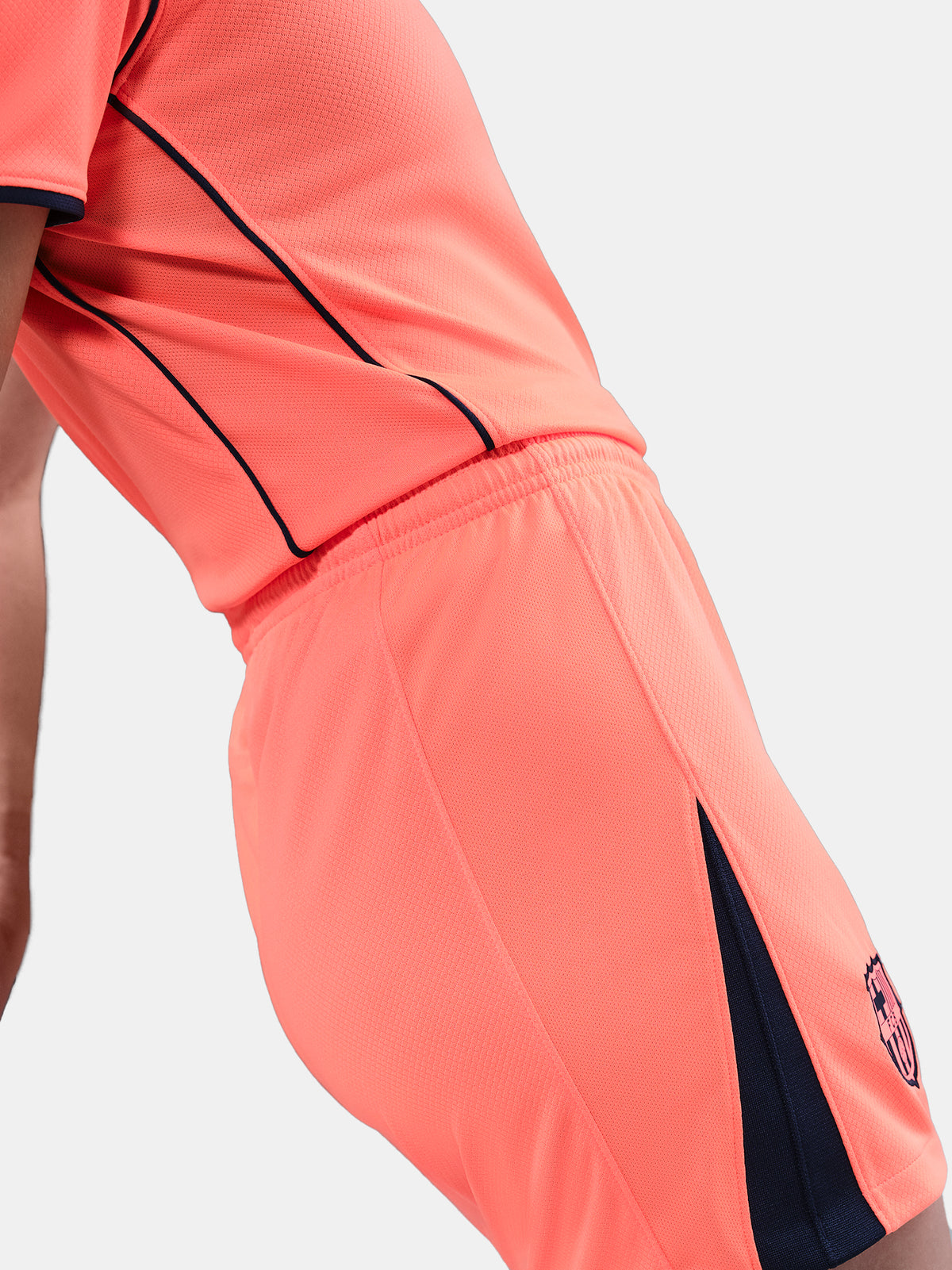 FC Barcelona third kit football shorts in orange with navy blue Nike logo and club crest