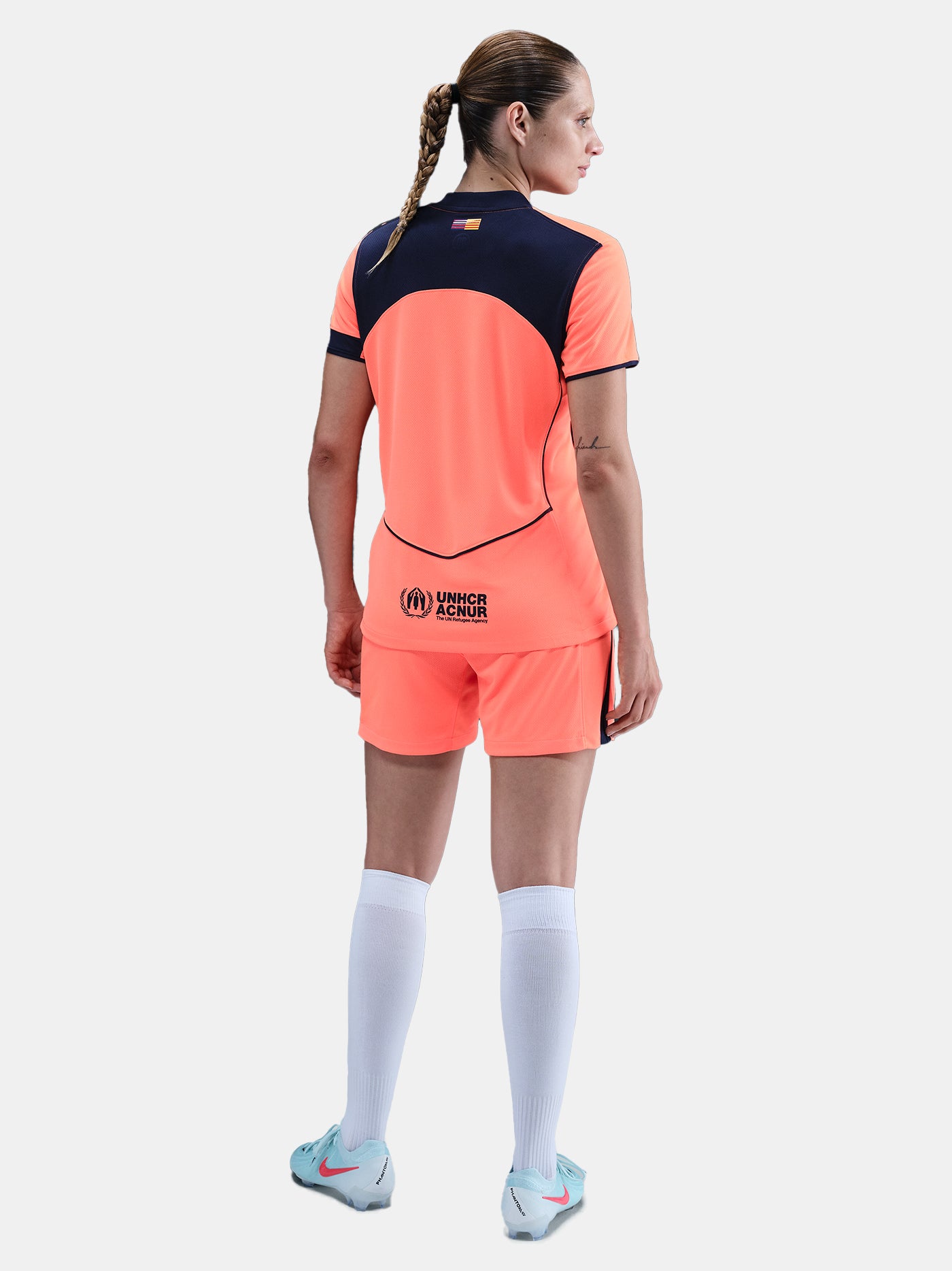 FC Barcelona third kit football shorts in orange with navy blue Nike logo and club crest