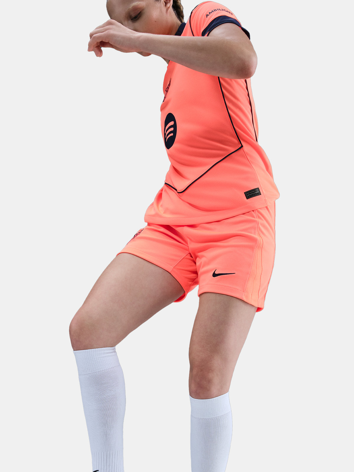 FC Barcelona third kit football shorts in orange with navy blue Nike logo and club crest