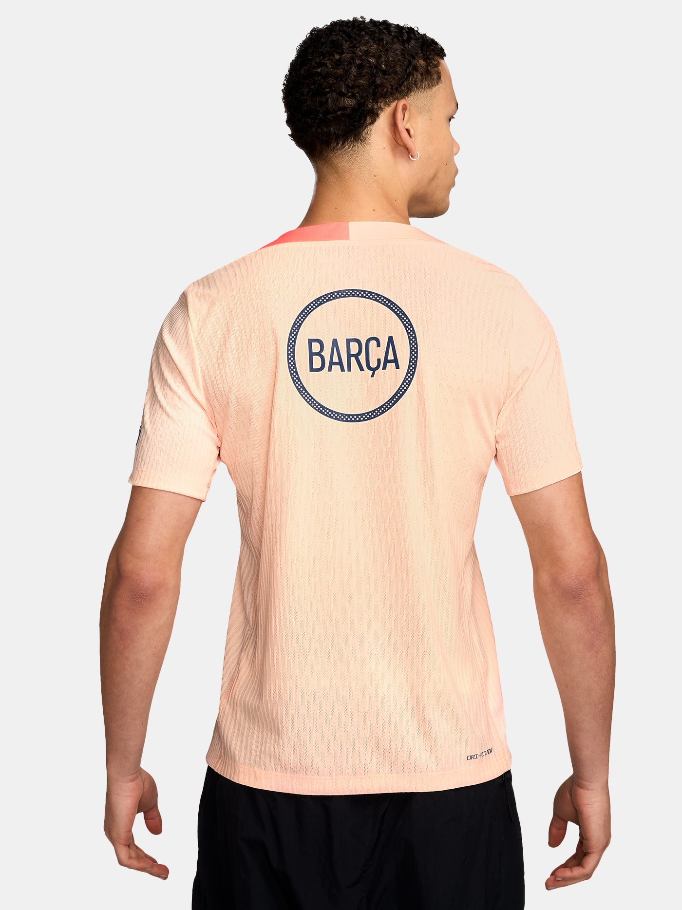 FC Barcelona light pink training jersey with navy Nike logo, Spotify sponsor, and club crest on the chest.