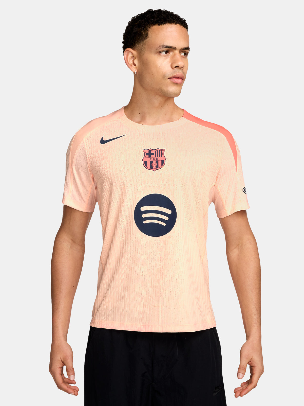 FC Barcelona light pink training jersey with navy Nike logo, Spotify sponsor, and club crest on the chest.