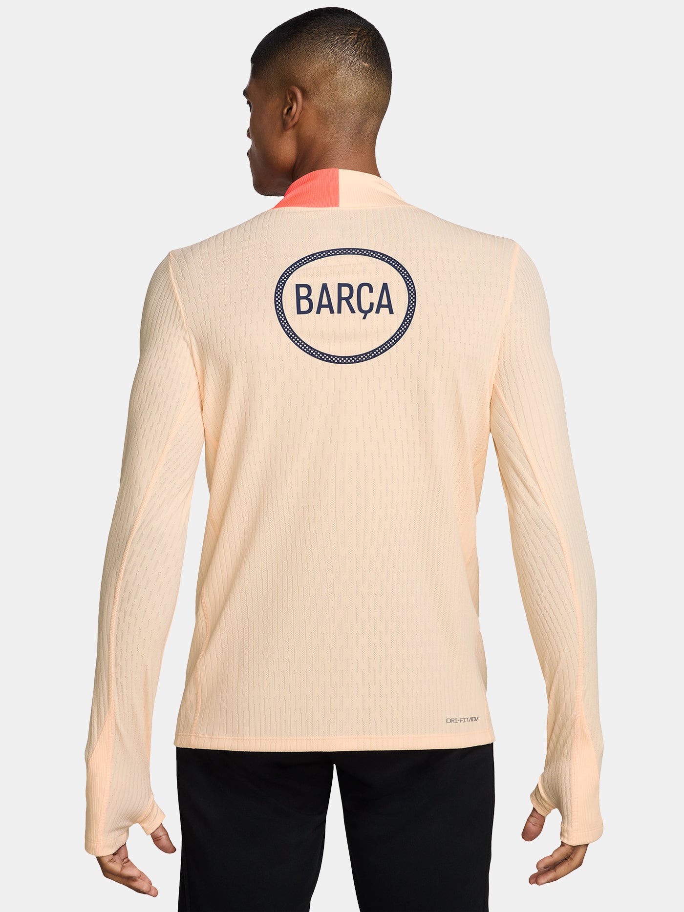 FC Barcelona long-sleeve peach training top with navy Nike logo, club crest, Spotify sponsor, and coral shoulder detail