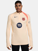 FC Barcelona long-sleeve peach training top with navy Nike logo, club crest, Spotify sponsor, and coral shoulder detail