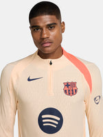 FC Barcelona long-sleeve peach training top with navy Nike logo, club crest, Spotify sponsor, and coral shoulder detail