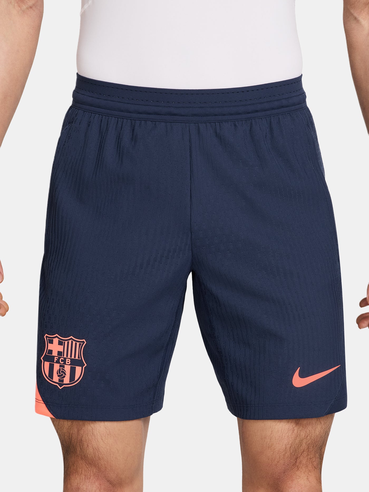 FC Barcelona navy blue training shorts with coral Nike logo and club crest