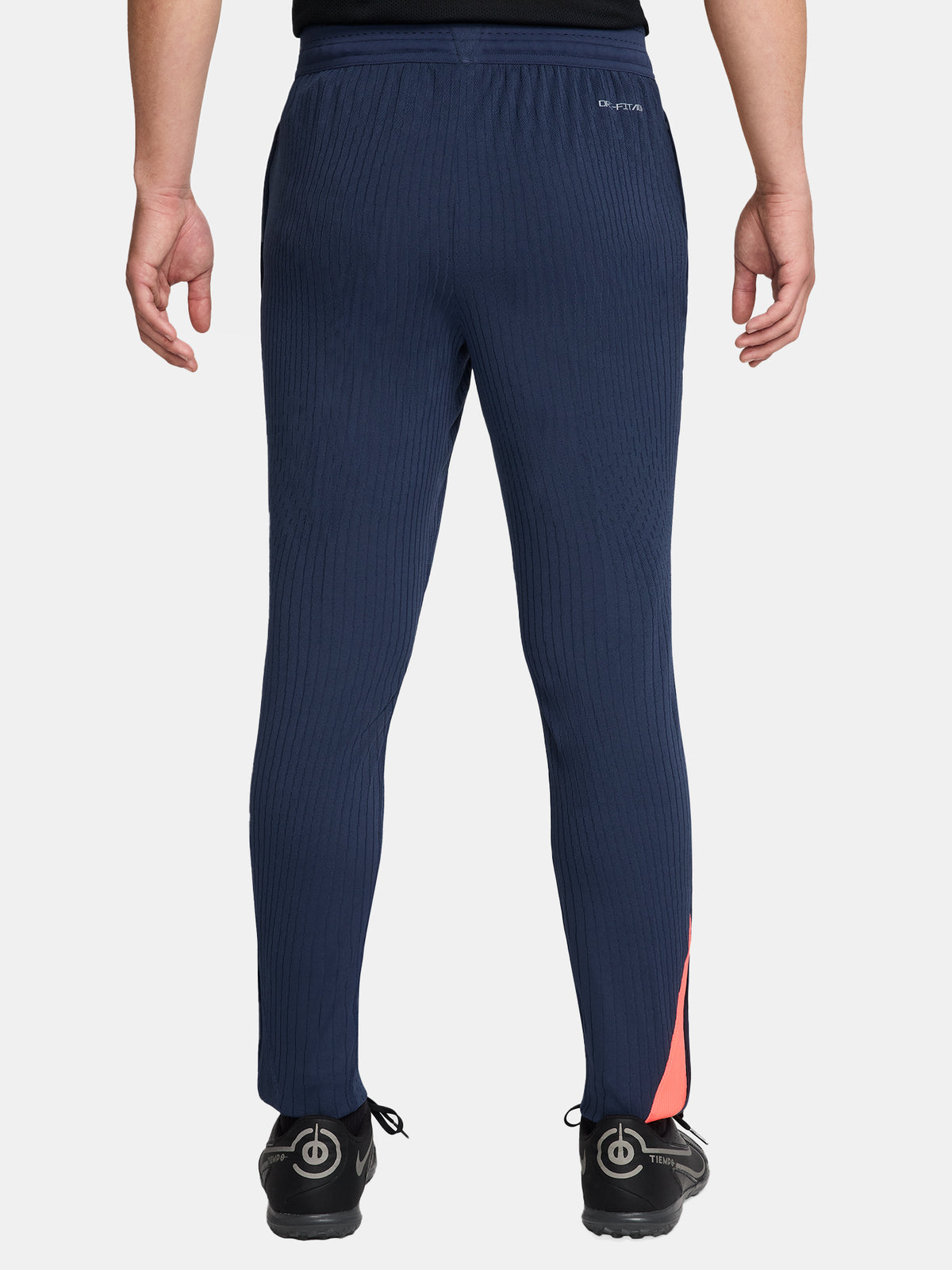 FC Barcelona navy blue training pants with slim fit, featuring the club crest and Nike logo in coral on the front