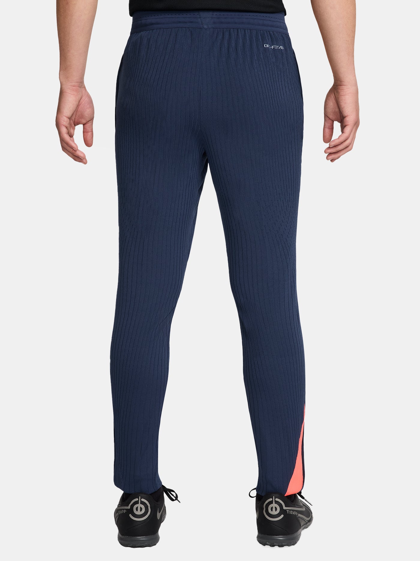 FC Barcelona navy blue training pants with slim fit, featuring the club crest and Nike logo in coral on the front