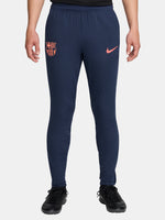 FC Barcelona navy blue training pants with slim fit, featuring the club crest and Nike logo in coral on the front