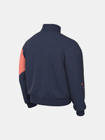 FC Barcelona navy blue jacket with coral details, including a coral sleeve, zipper, Nike logo, and club crest, paired with white Nike pants.