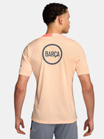 FC Barcelona light pink training jersey with navy Nike logo, Spotify sponsor, and club crest on the chest.