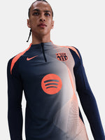 FC Barcelona navy long-sleeve training top with coral Nike logo, Spotify sponsor, and modern coral and white geometric pattern across the chest and shoulders.