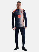 FC Barcelona navy long-sleeve training top with coral Nike logo, Spotify sponsor, and modern coral and white geometric pattern across the chest and shoulders.